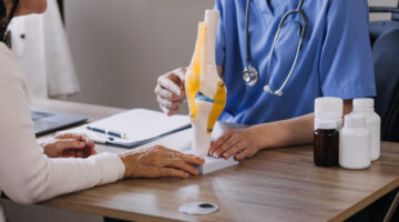 Doctor sitting with person