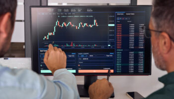 stock traders looking at charts